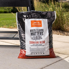 Traeger pellets being loaded into a grill hopper demonstrating easy feed reliability