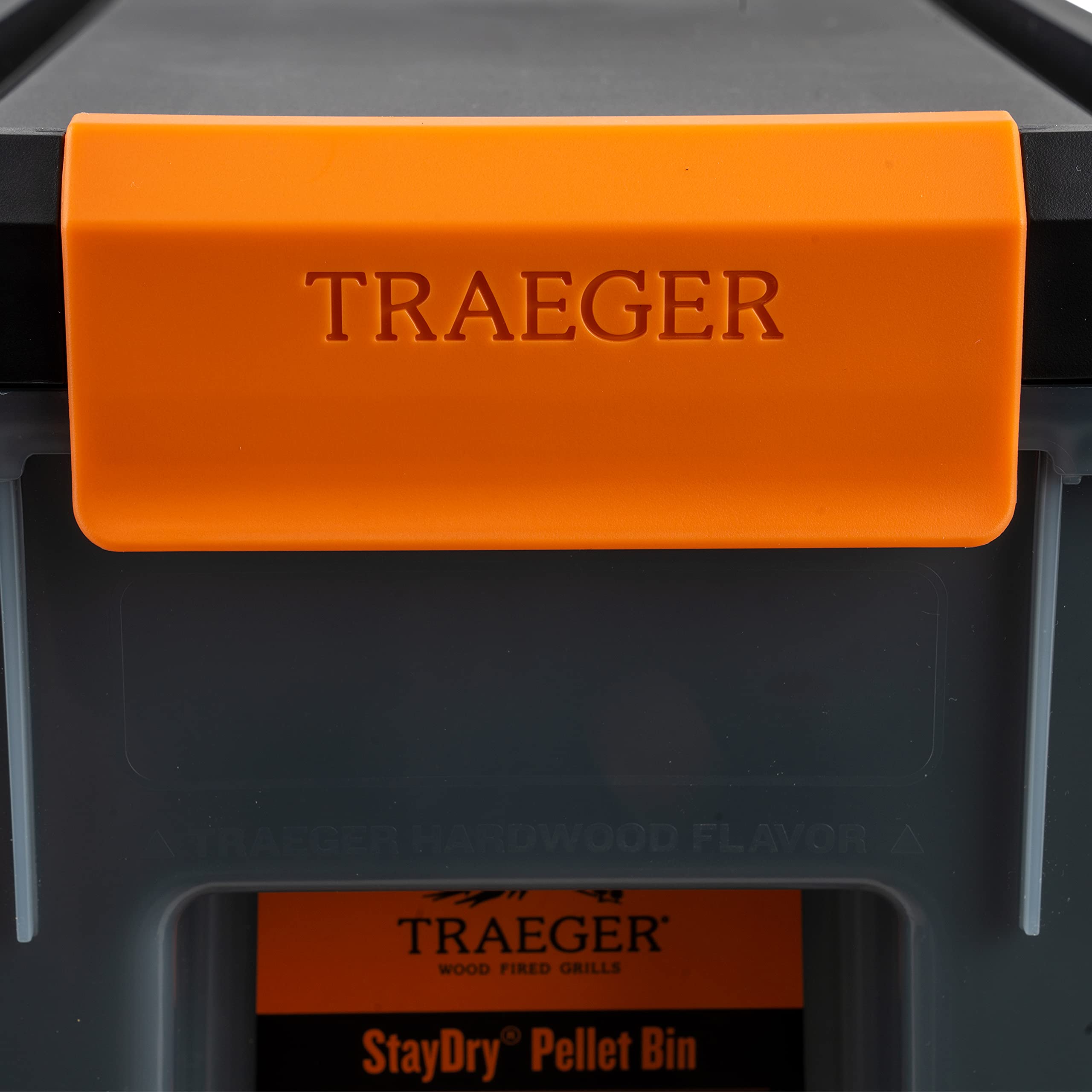 Traeger bin placed in backyard near grill for tidy, protected pellet storage