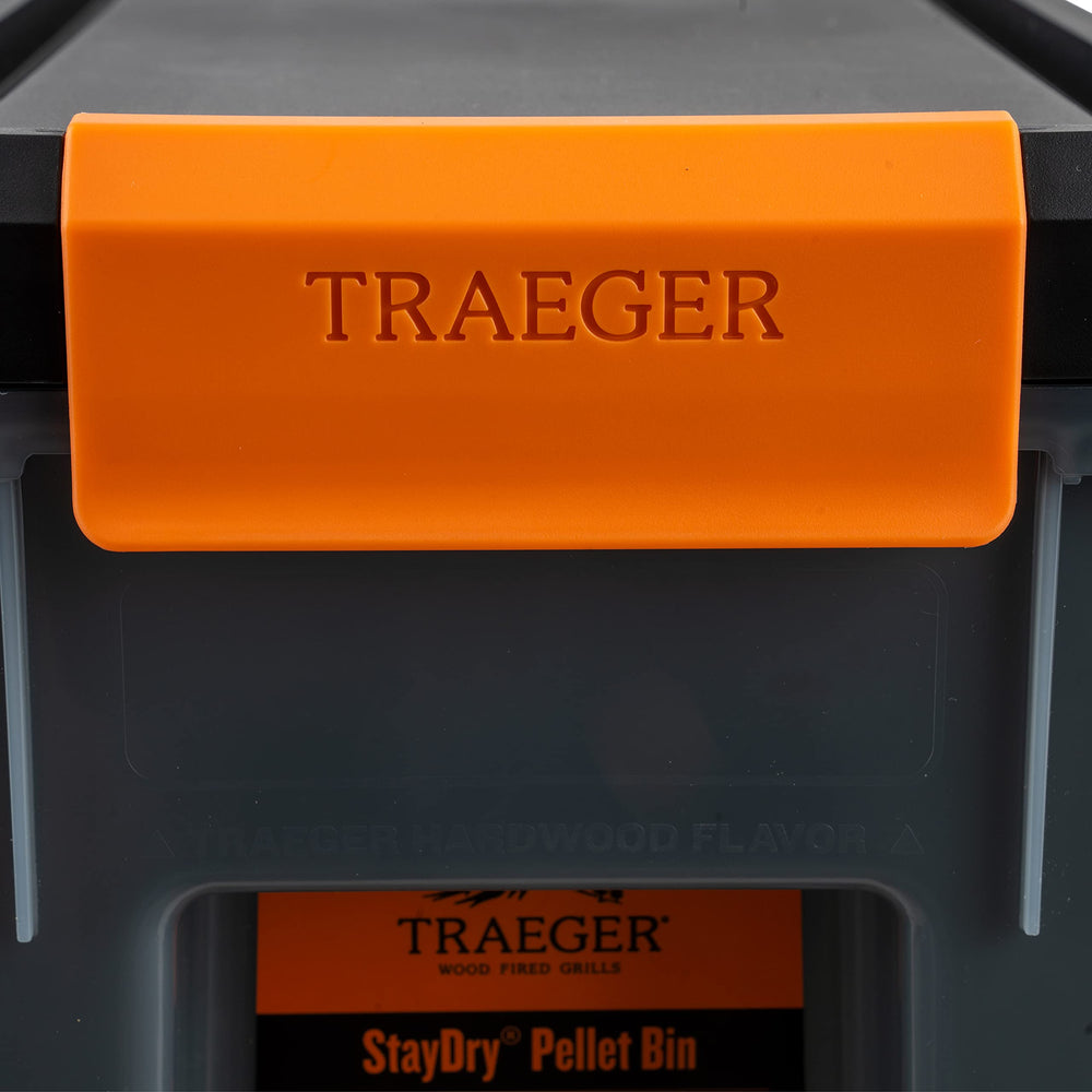 Traeger bin placed in backyard near grill for tidy, protected pellet storage