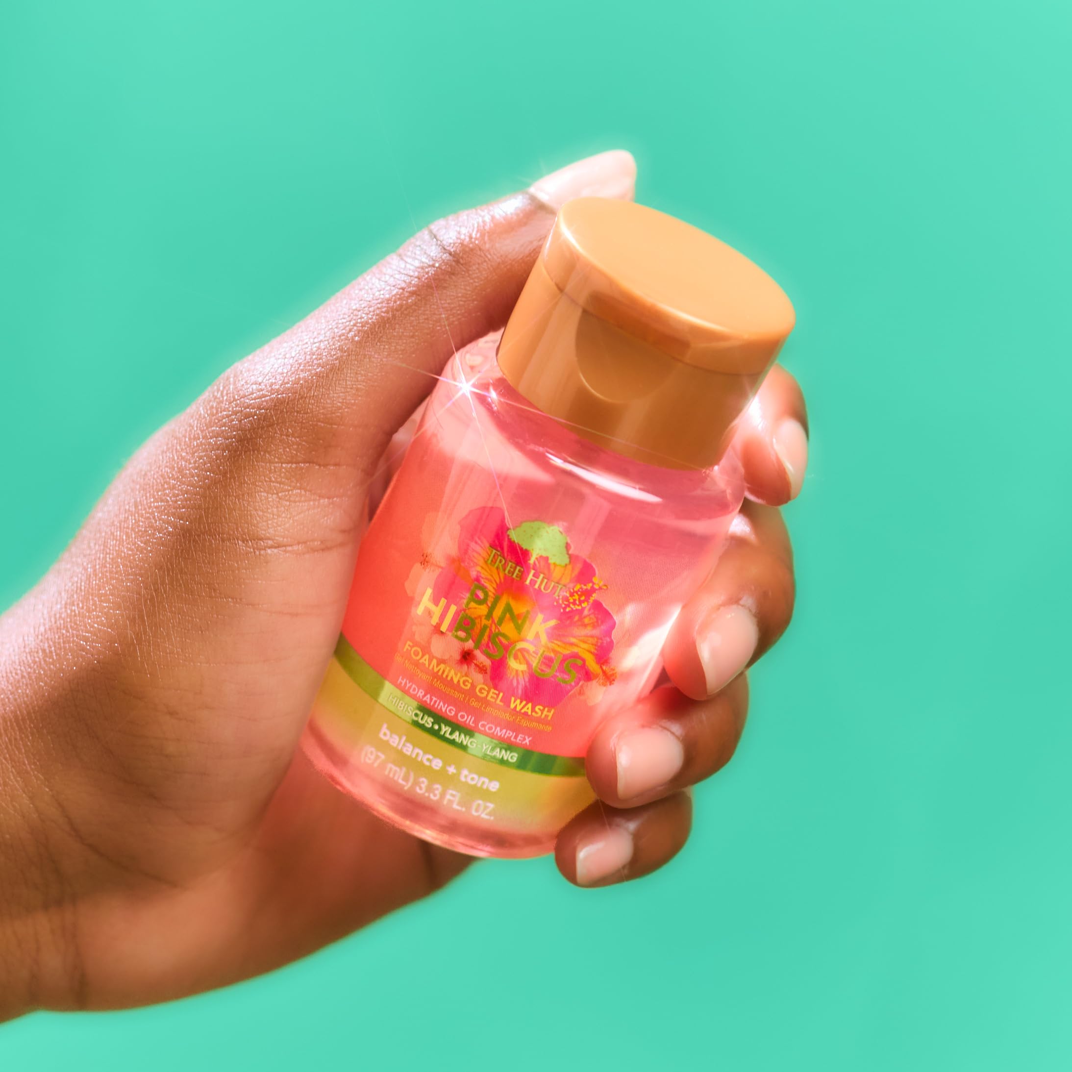 Tree Hut bottle held in hand showing travel size and portability benefit