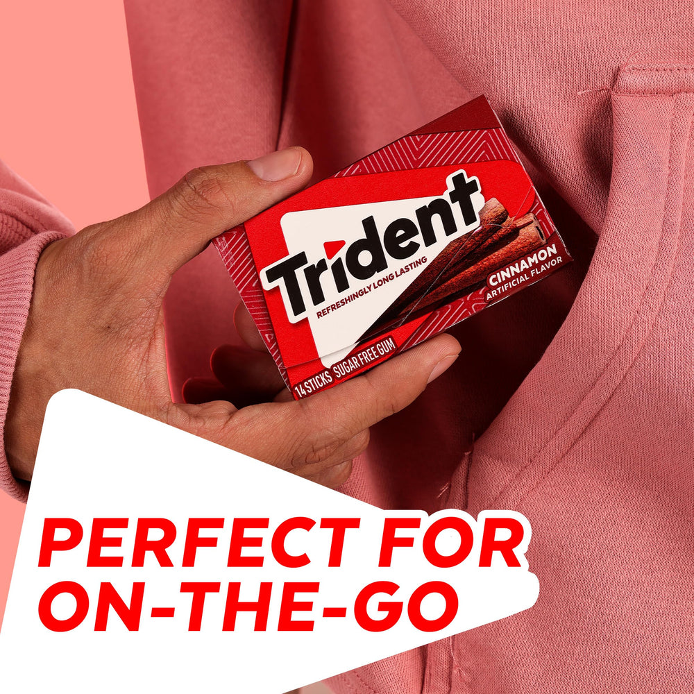 Person chewing Trident cinnamon stick showing fresh flavor enjoyment