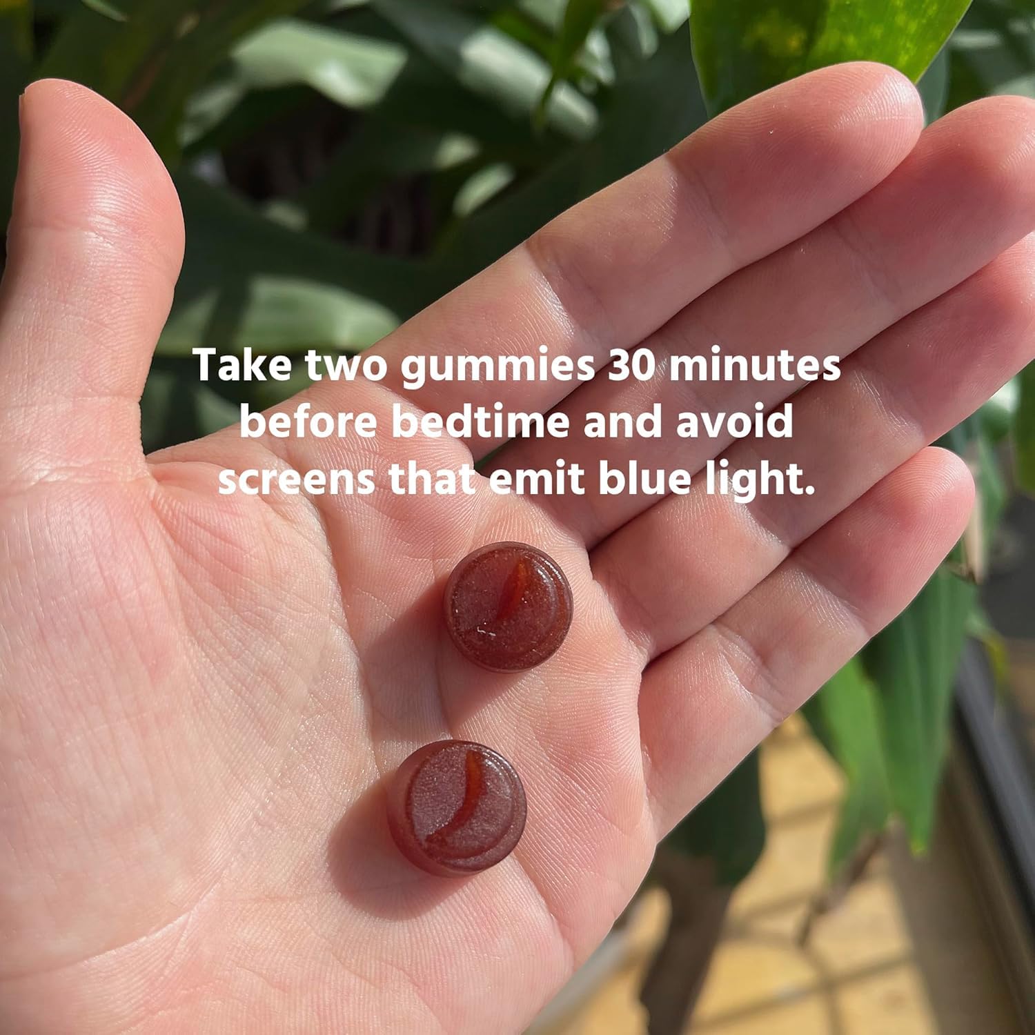 TruHeight two gummies in hand displaying suggested single dose size
