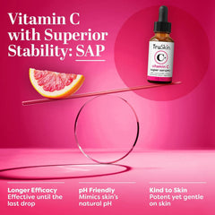 TruSkin bottle beside vitamin C and rosehip illustrating active ingredients