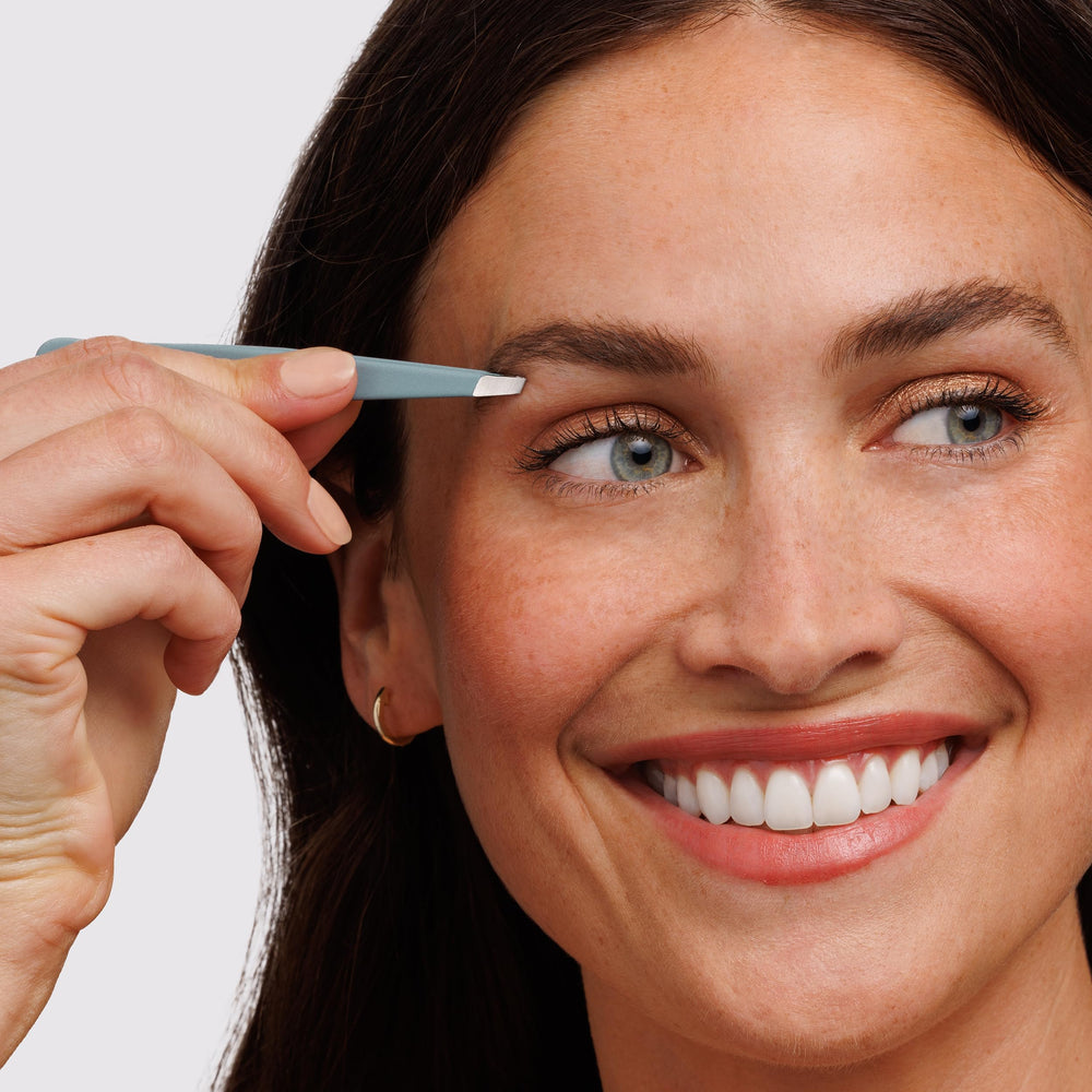 Tweezerman in use removing eyebrow hair for cleaner shaping result