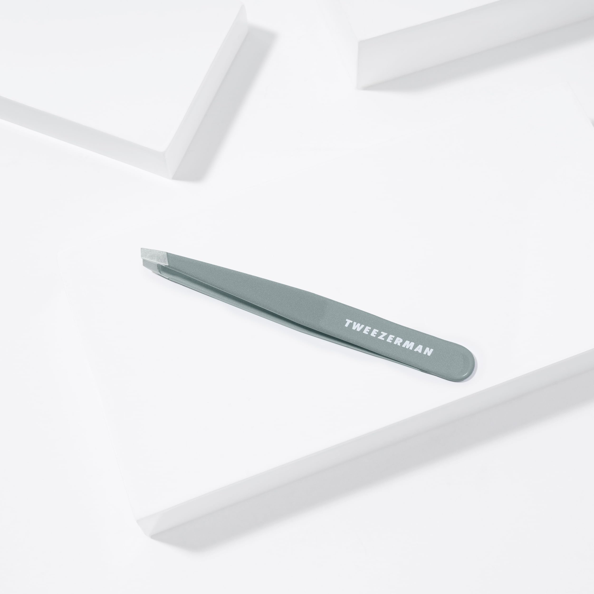 Tweezerman tips gripping a single hair illustrating accurate removal