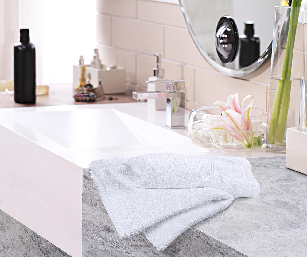 Utopia Towels held in a hand to show 16x28 size and practical usability