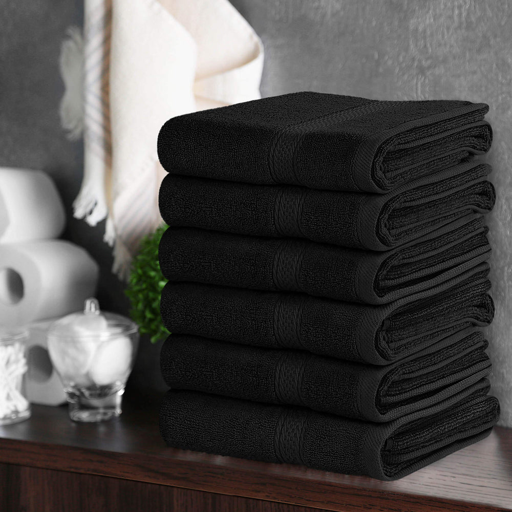 Utopia Towels being used to dry hands at a sink, illustrating everyday absorbent performance