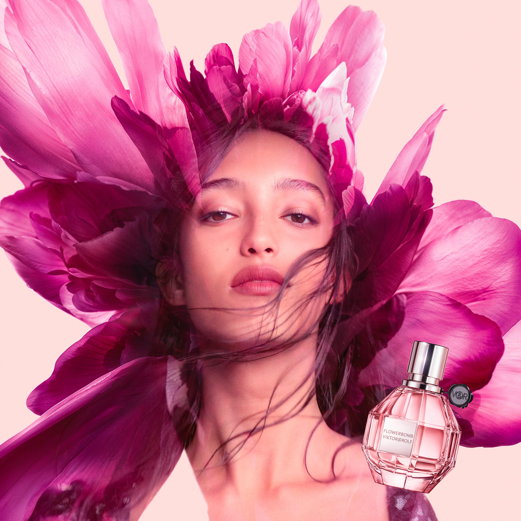 Viktor&Rolf bottle held in hand showing compact size and travel convenience