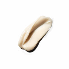 Hands holding VIRTUE conditioner to showcase gentle lather and detangling effect