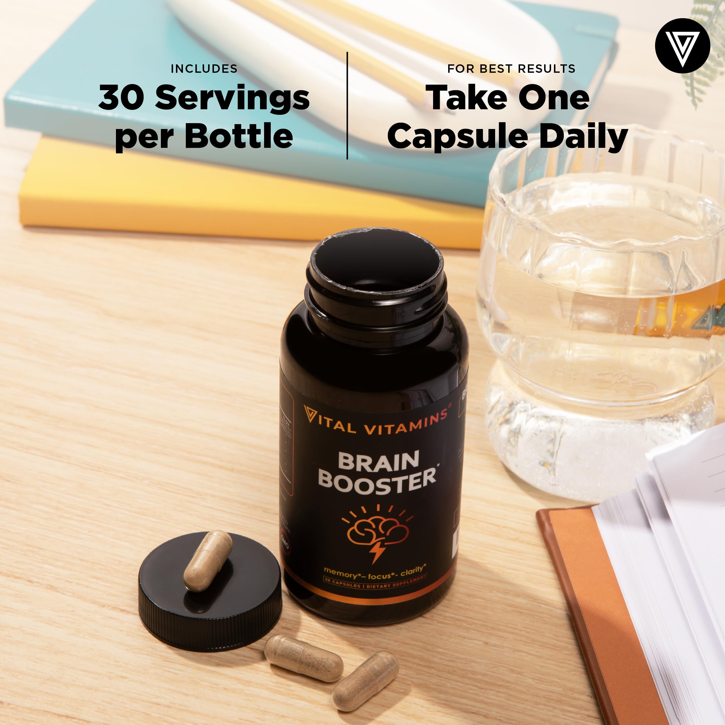 Vital Vitamins bottle on a desk with laptop showing focus during work