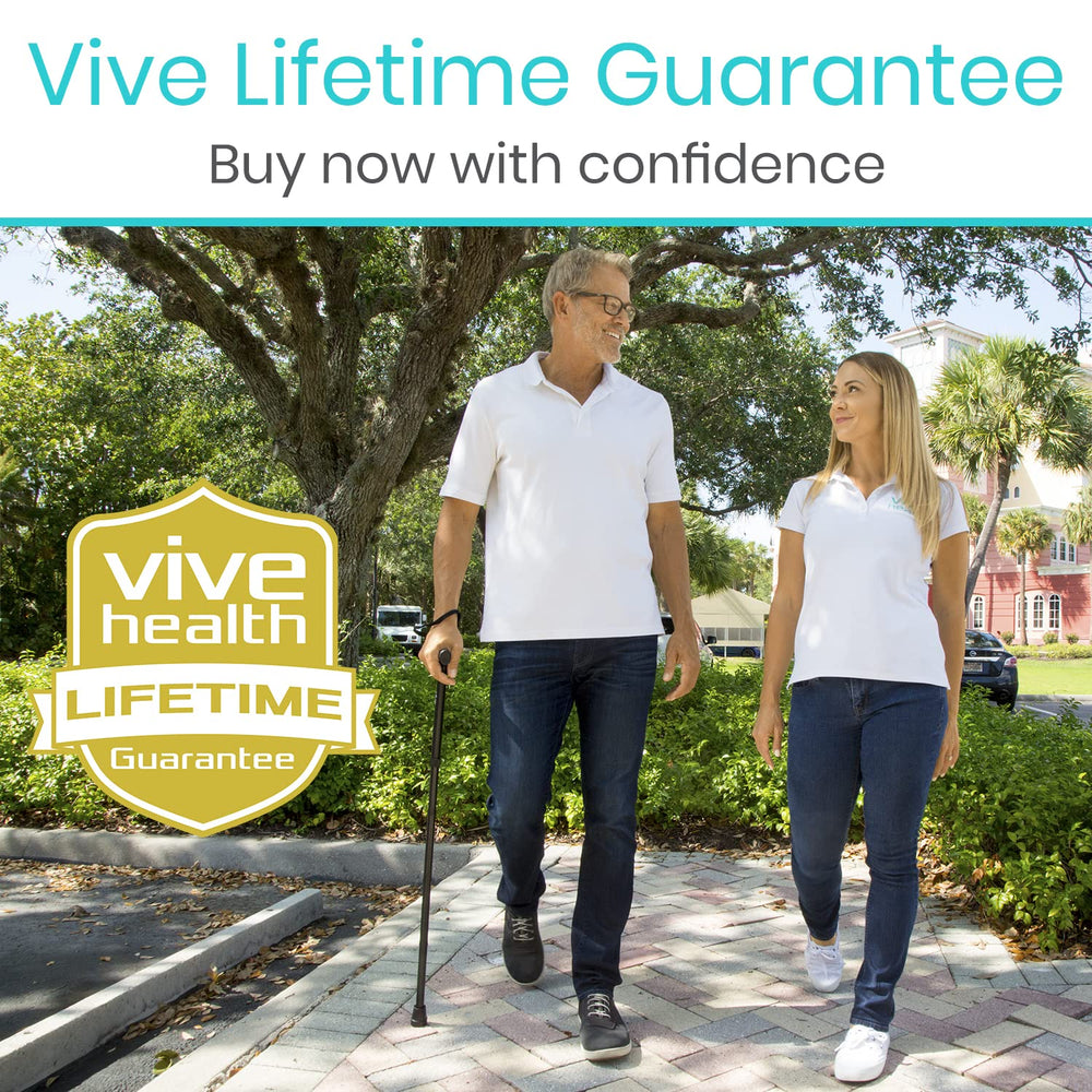 Vive folding cane next to a hand for scale showing compact folded size and easy handling