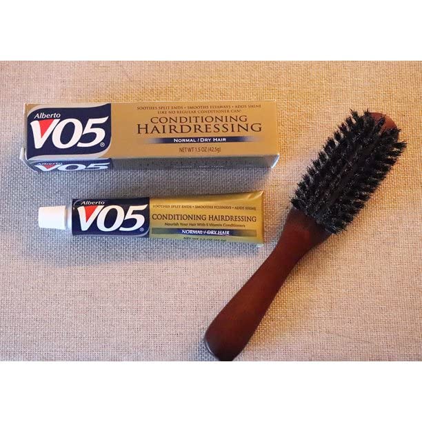 Alberto VO5 conditioner being applied to hair for frizz control