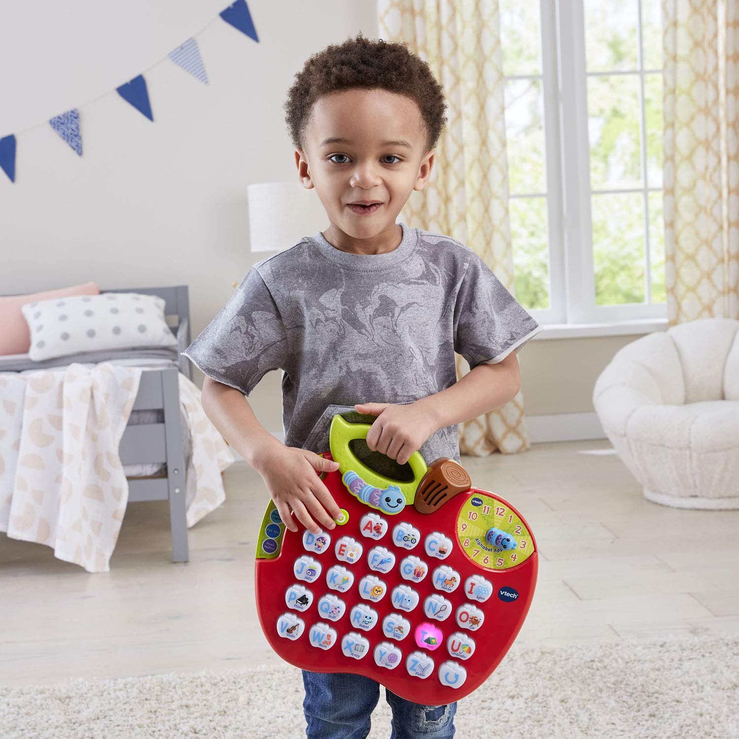 VTech ABC Learning Apple child interacting with buttons to build letters, memory and fun