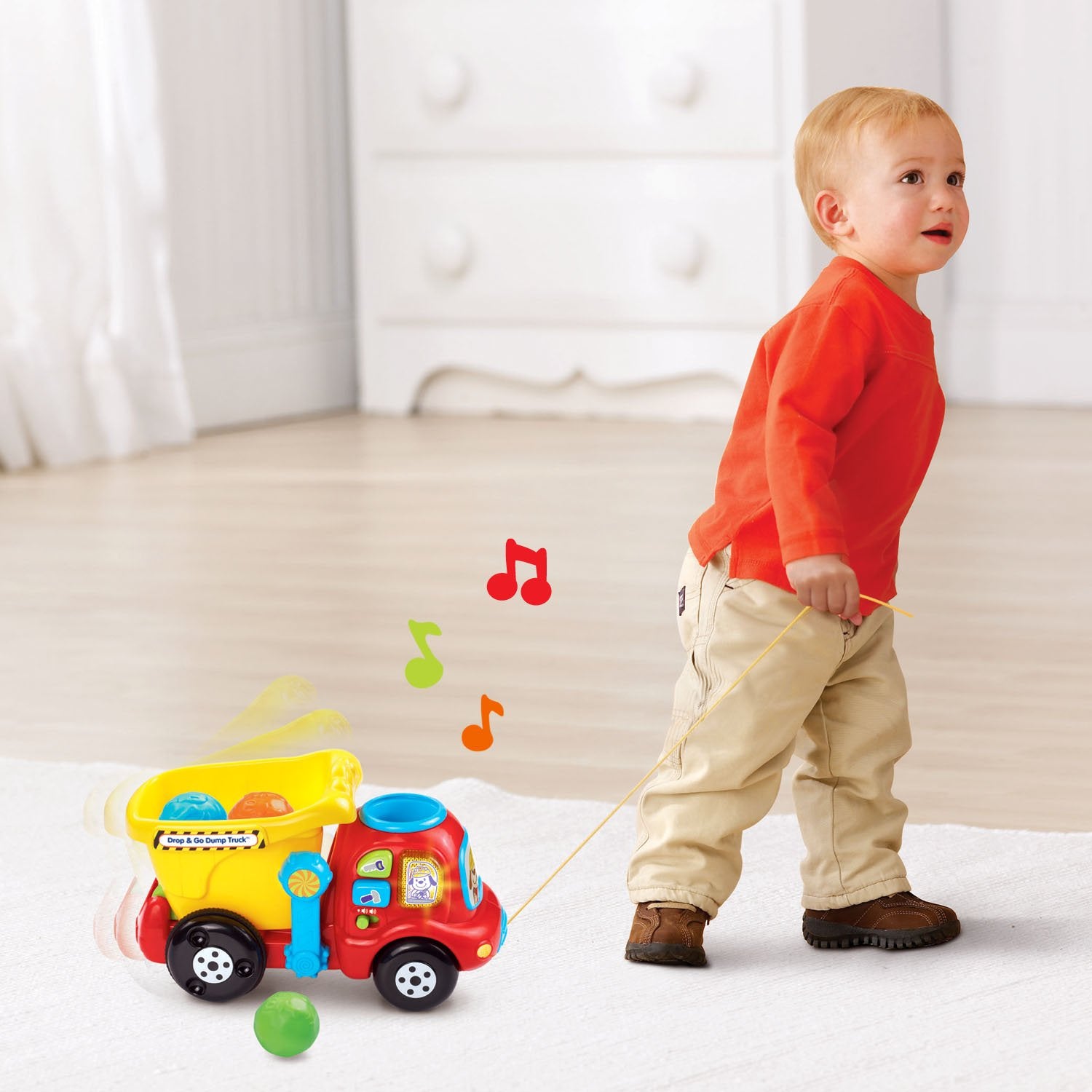 VTech hinged bucket open to show easy unloading and motor skill practice