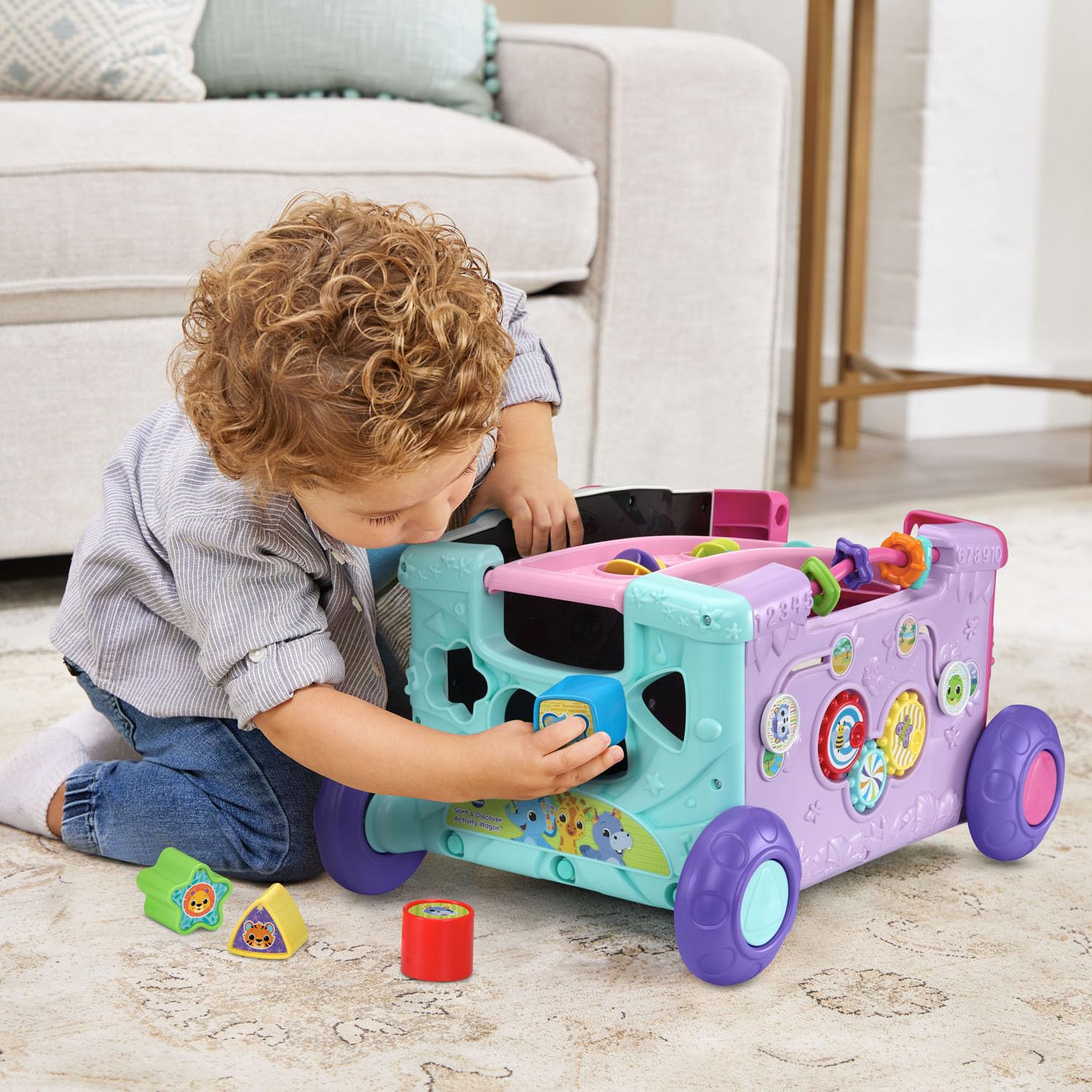 VTech toddler pushing wagon illustrating balance support for early walkers