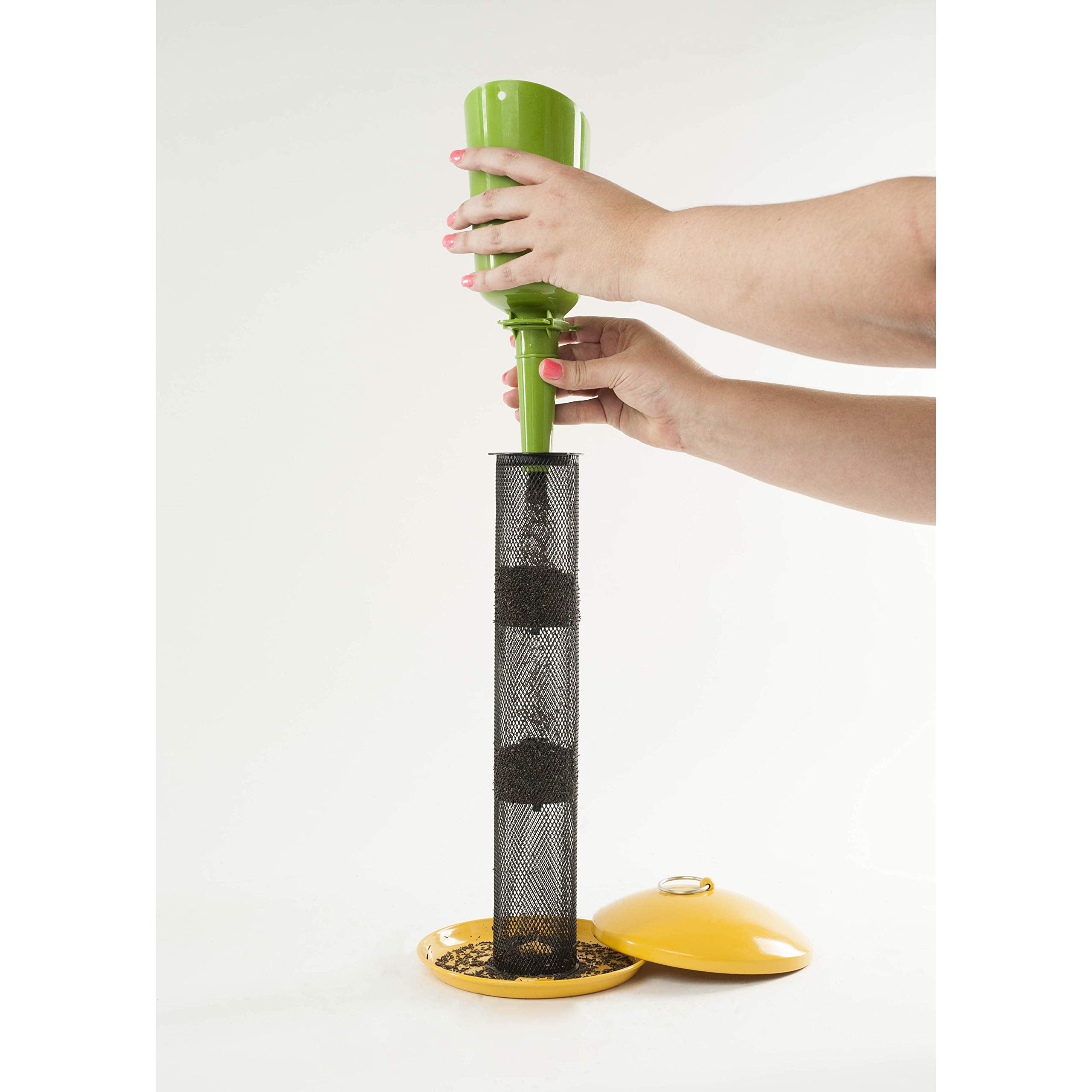 clean ground beneath feeder with Wagner's nyjer showing reduced mess
