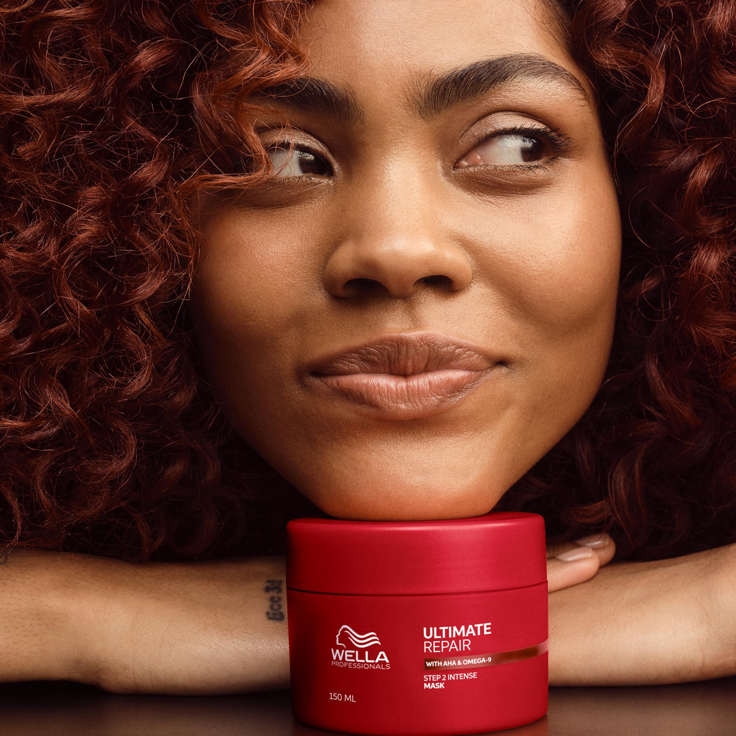 Wella Professionals stylist applying mask to sections for targeted repair