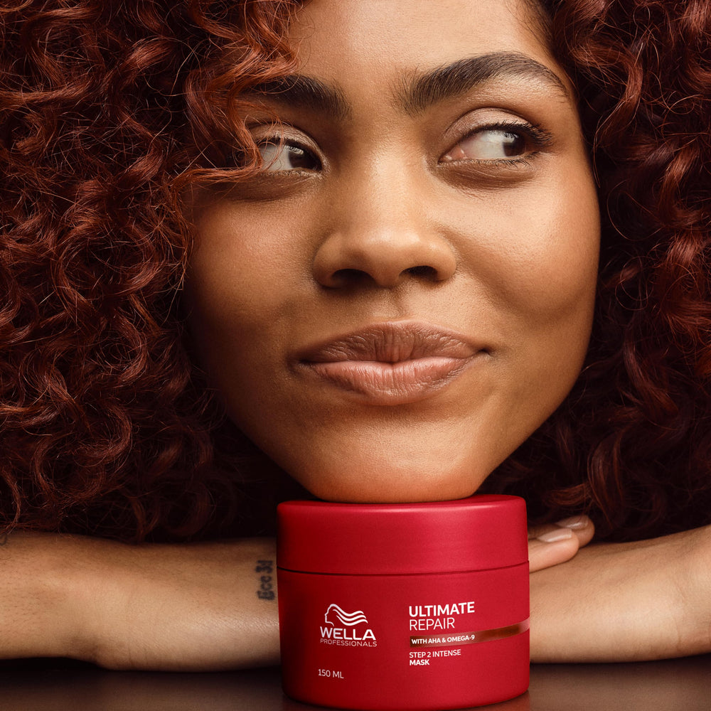 Wella Professionals stylist applying mask to sections for targeted repair