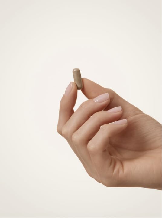 WELLBEL capsule in hand showing size and easy daily dosing