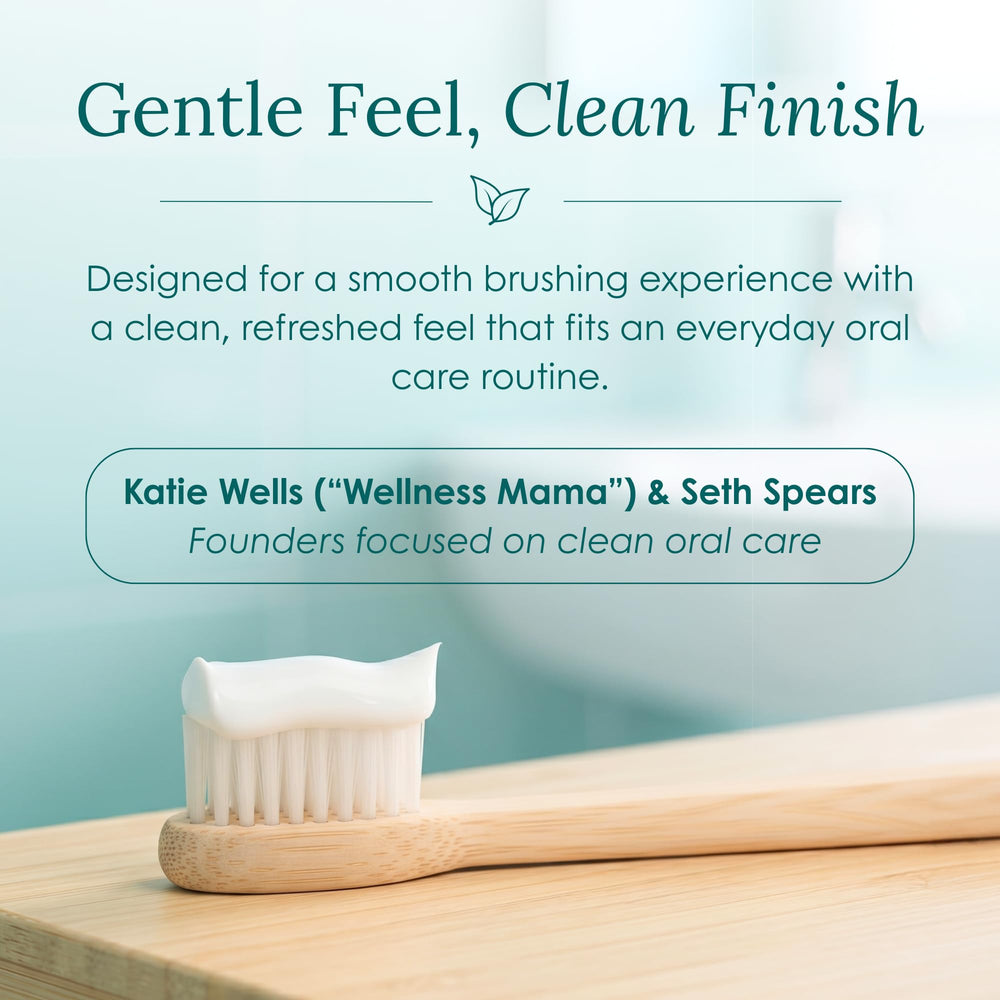 Wellnesse 4 oz tube beside toothbrush showing compact, travel-ready size