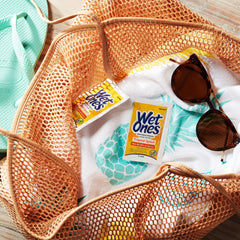 Wet Ones wipe in use on hands showing quick cleanup and smoother-feeling skin