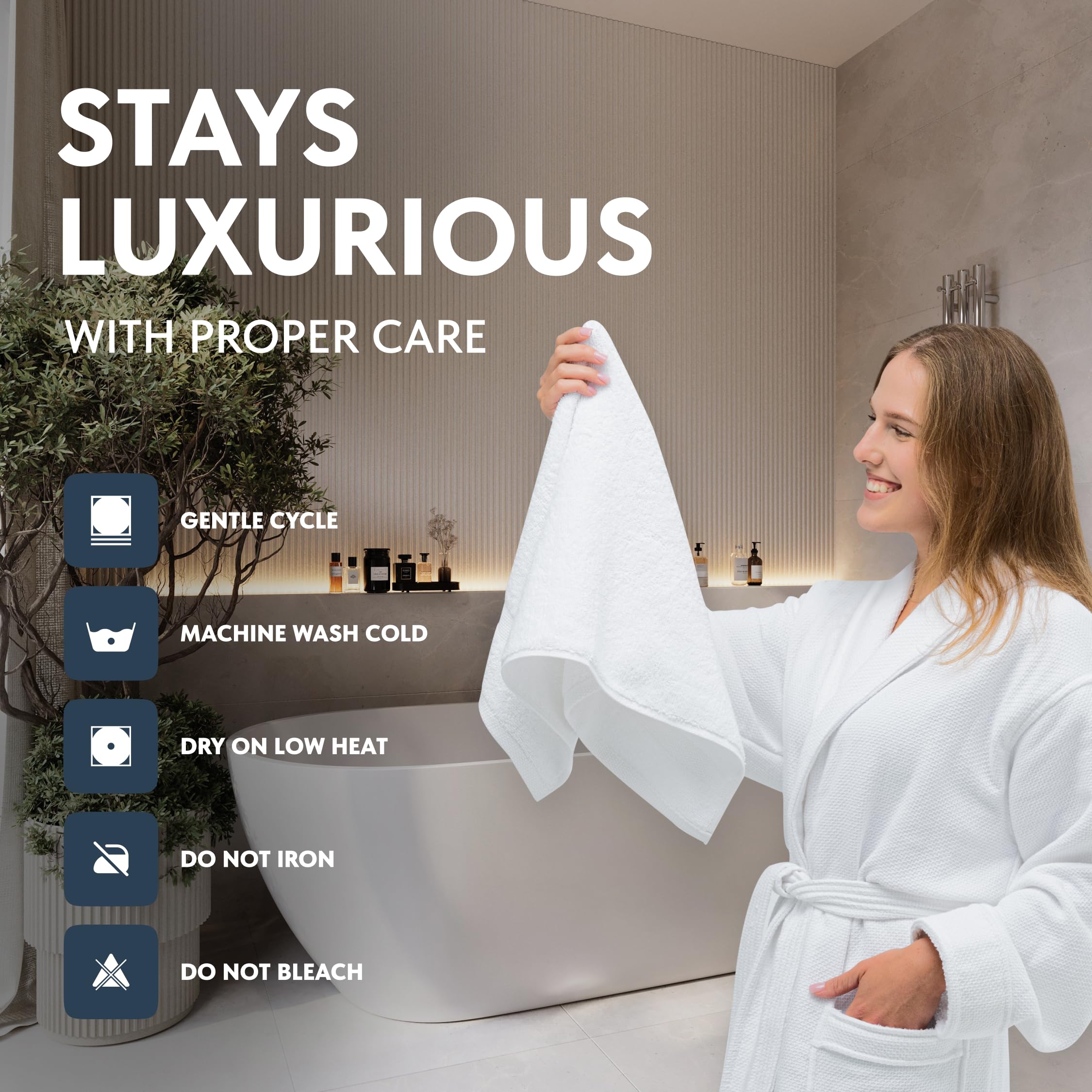White Classic towel held in hand showing generous 16x30 size and practical coverage