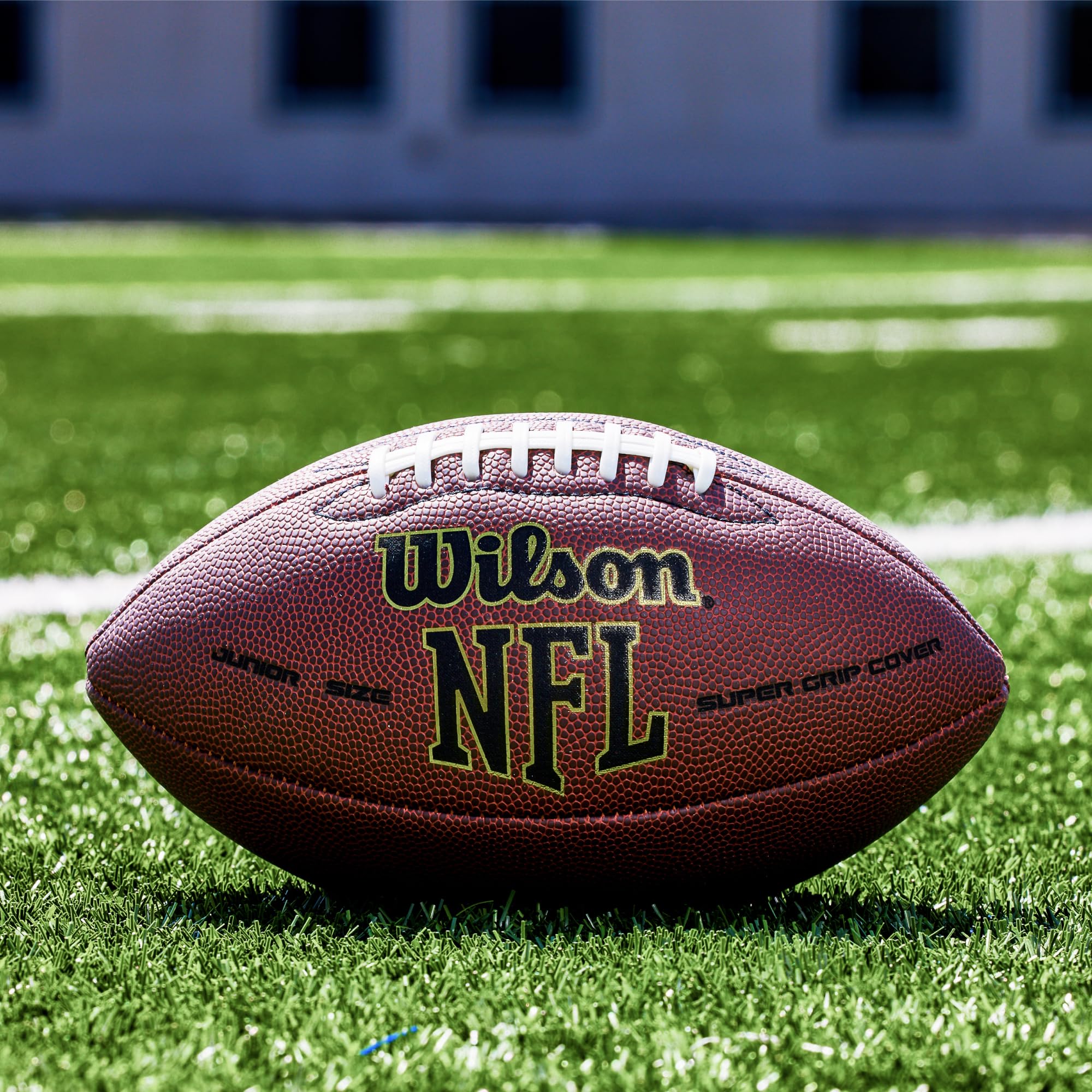 WILSON ball in mid-pass on field illustrating reliable flight and on-field performance