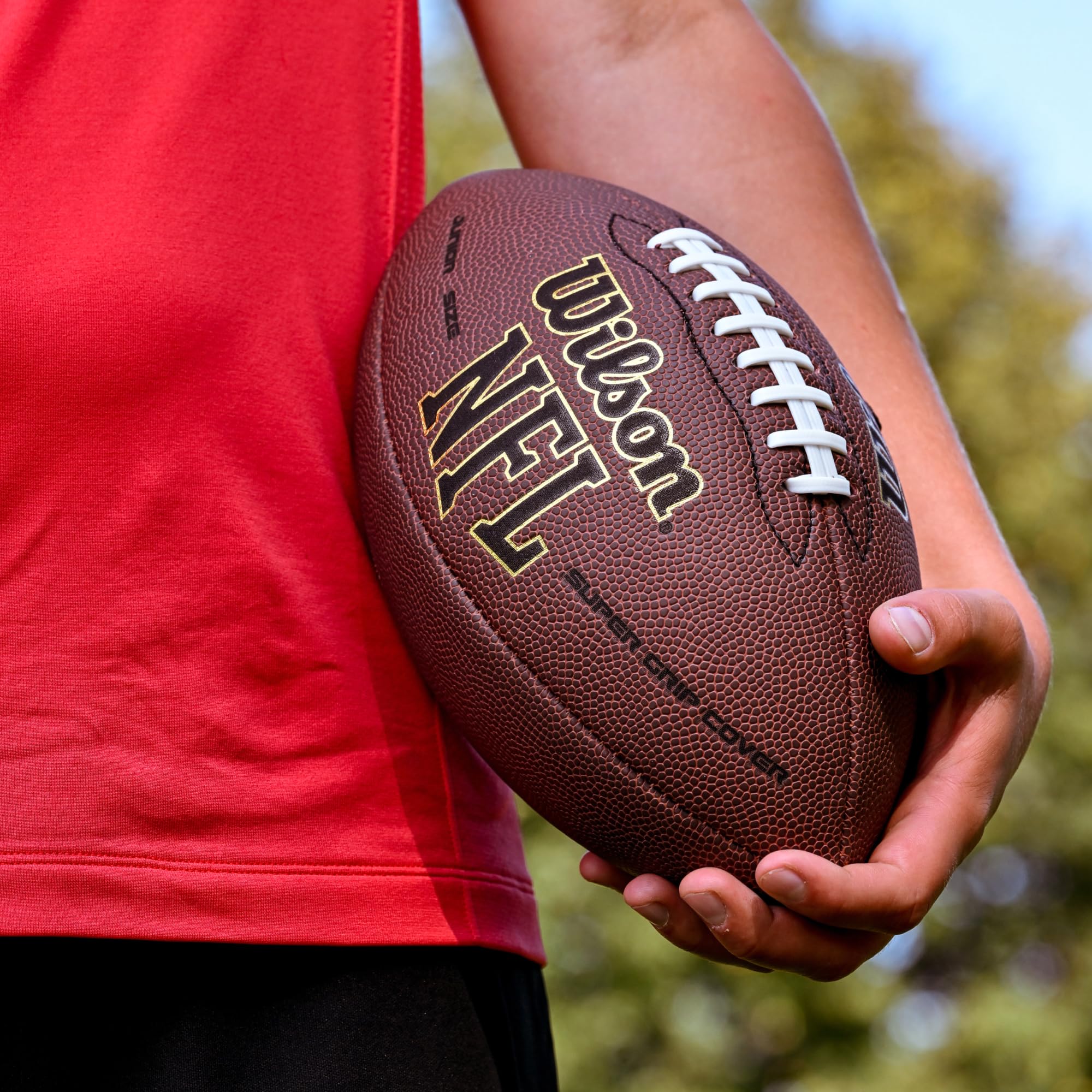 WILSON lifestyle field shot with players using ball to show real-game durability and feel