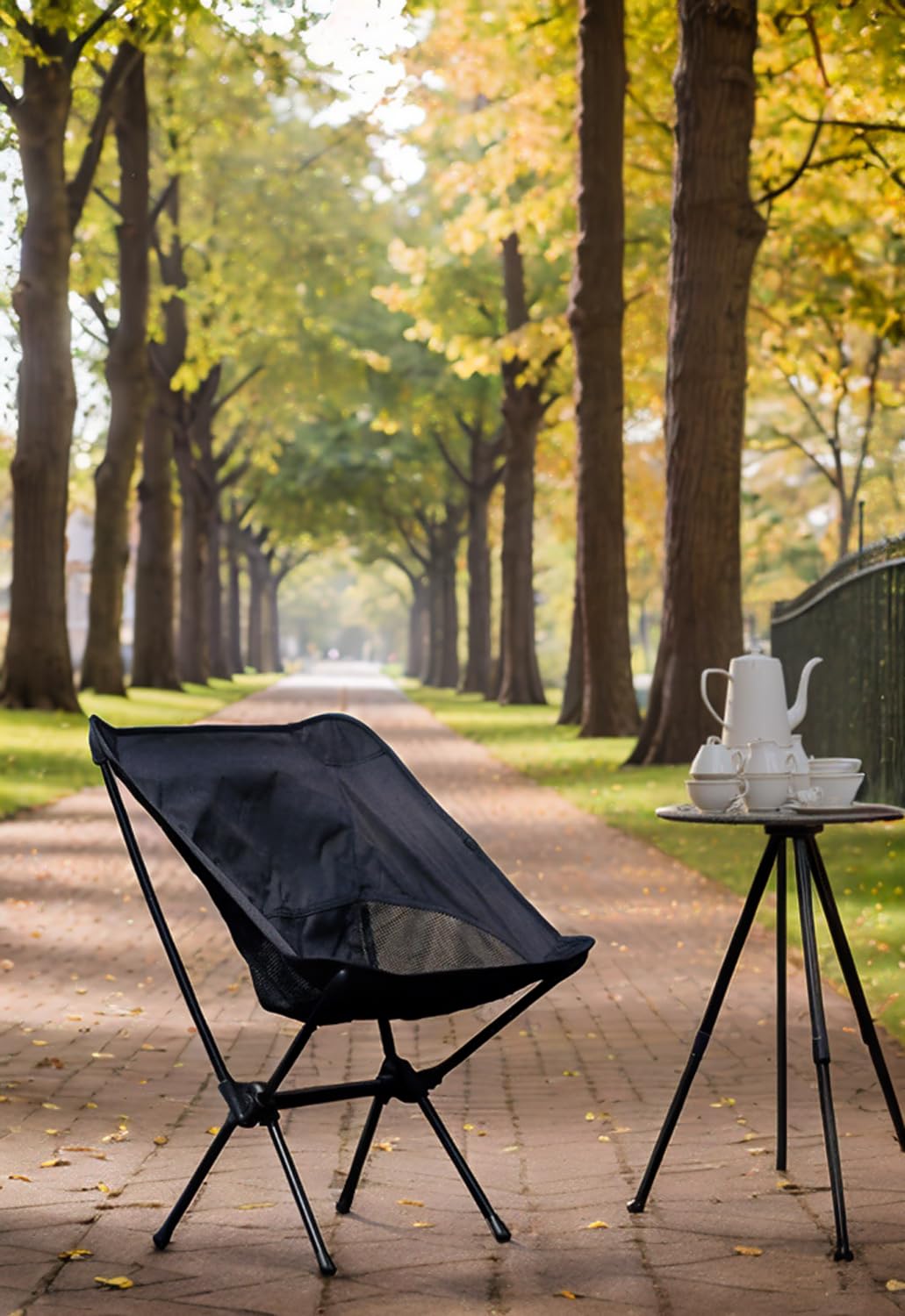 Wind Tour chair beside backpack demonstrating compact folded size for travel