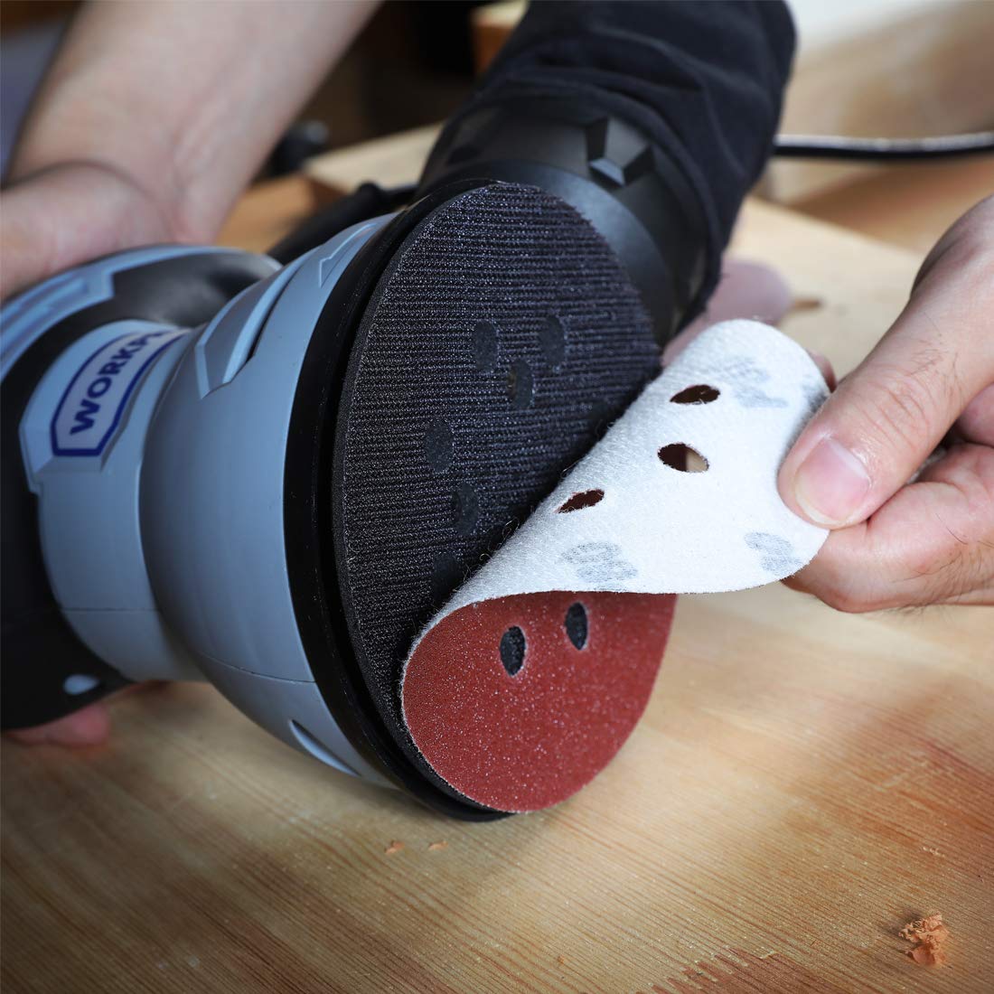 WORKPRO hand holding 5-inch disc showing scale and easy handling benefit