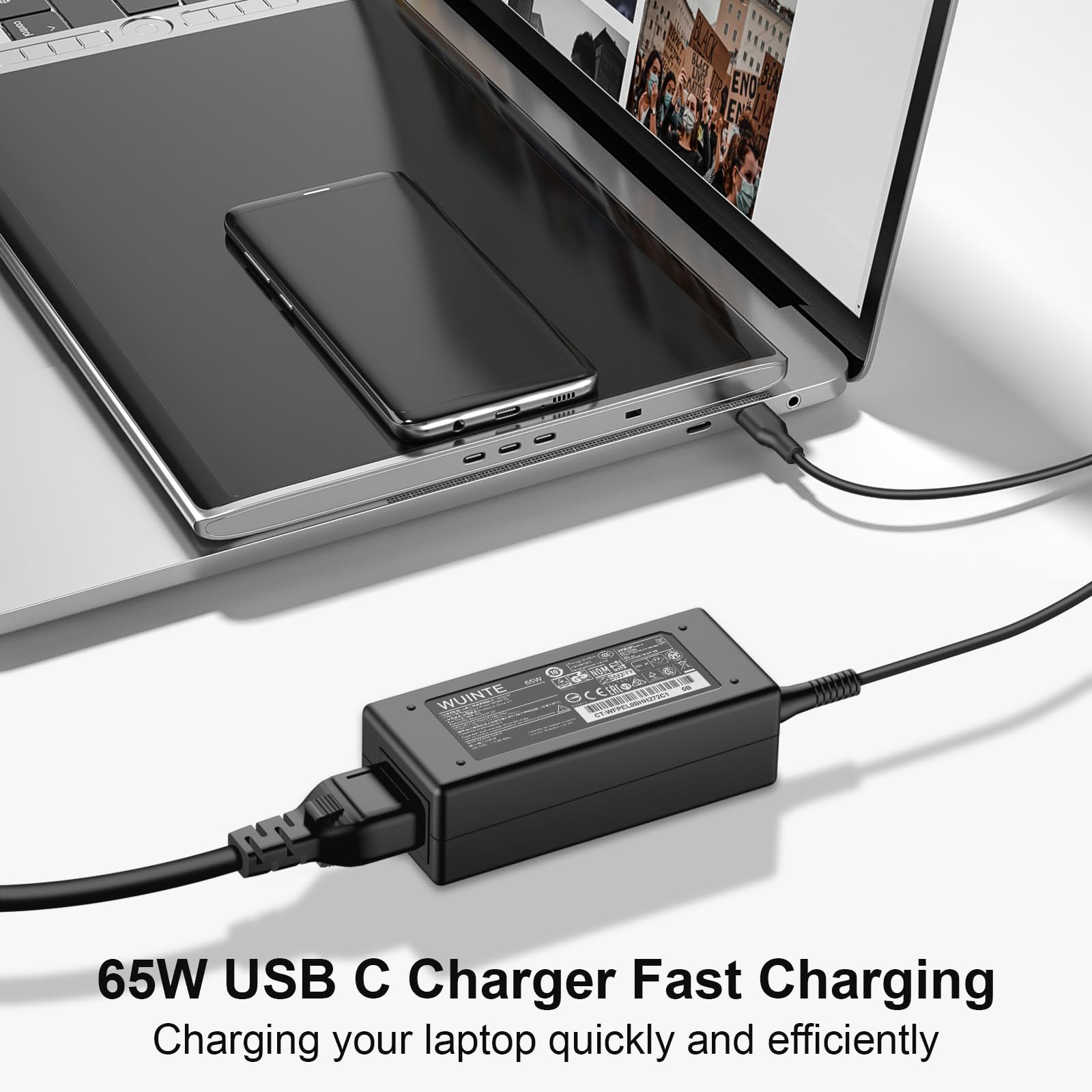 WUINTE charger plugged into a laptop demonstrating reliable charging during work