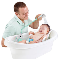 Yookidoo in sink being used one-handed to rinse baby with confidence
