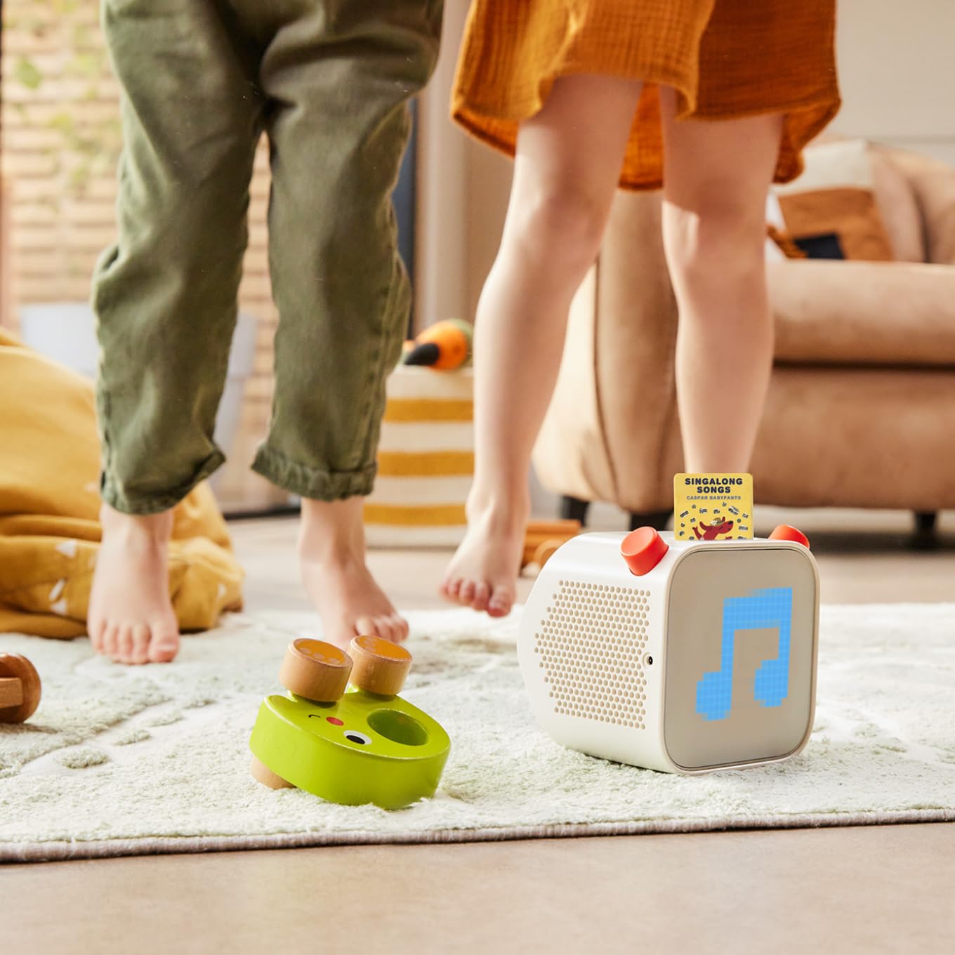 Child using Yoto cards with caregiver, encouraging imaginative screen-free listening