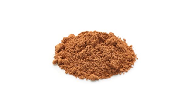 Measured scoop of Yupik cocoa powder ready for baking to ensure accurate results