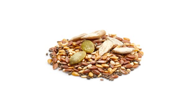 Yupik seeds next to a tablespoon for size and portion guidance