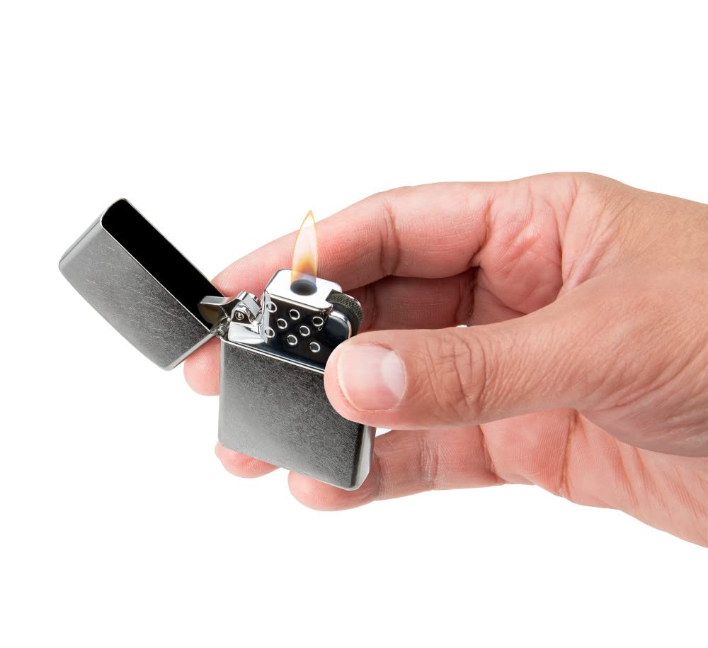 Zippo yellow flame insert beside a coin to show scale and portability benefit